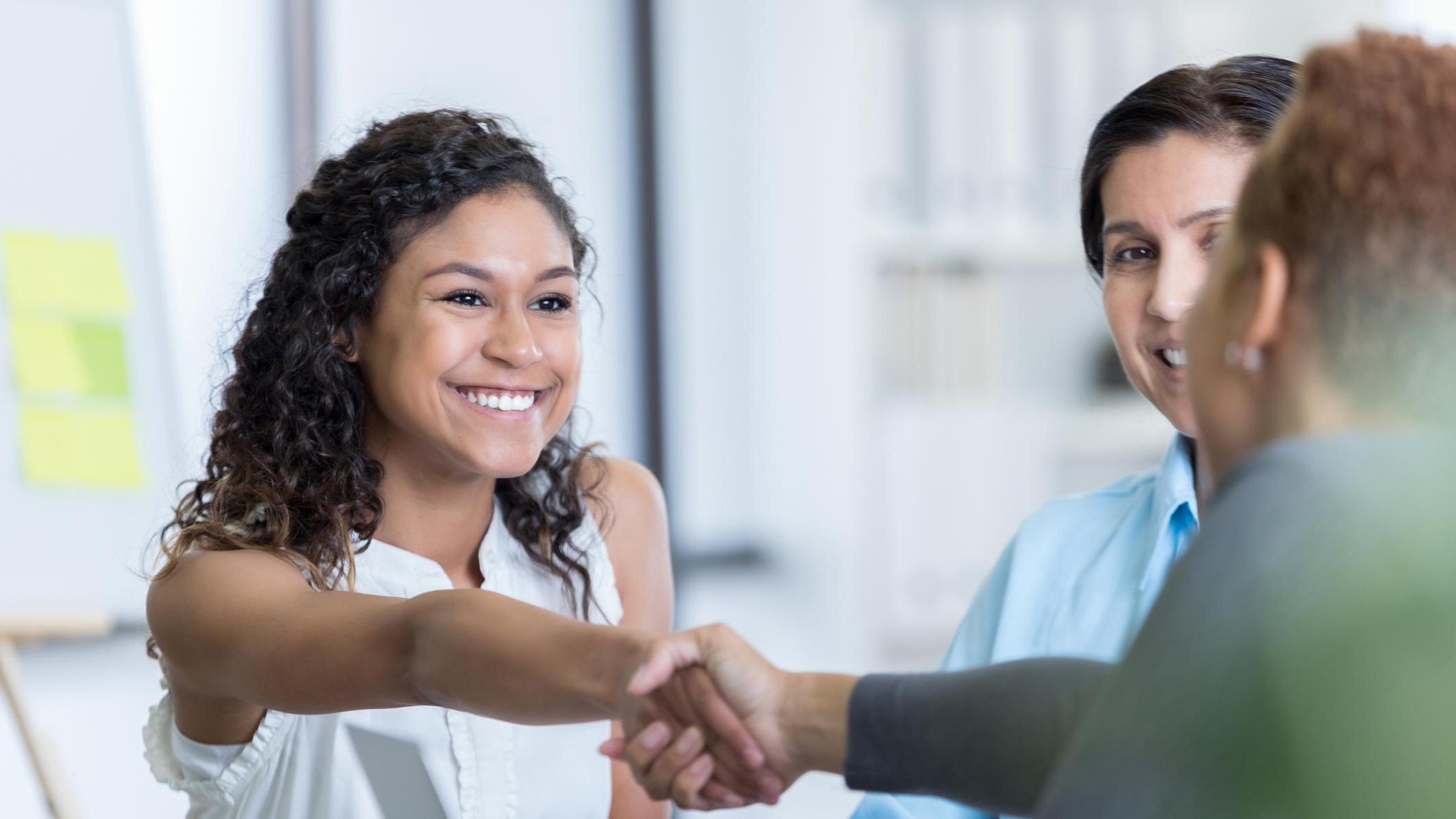 latino woman shaking hands in partnership